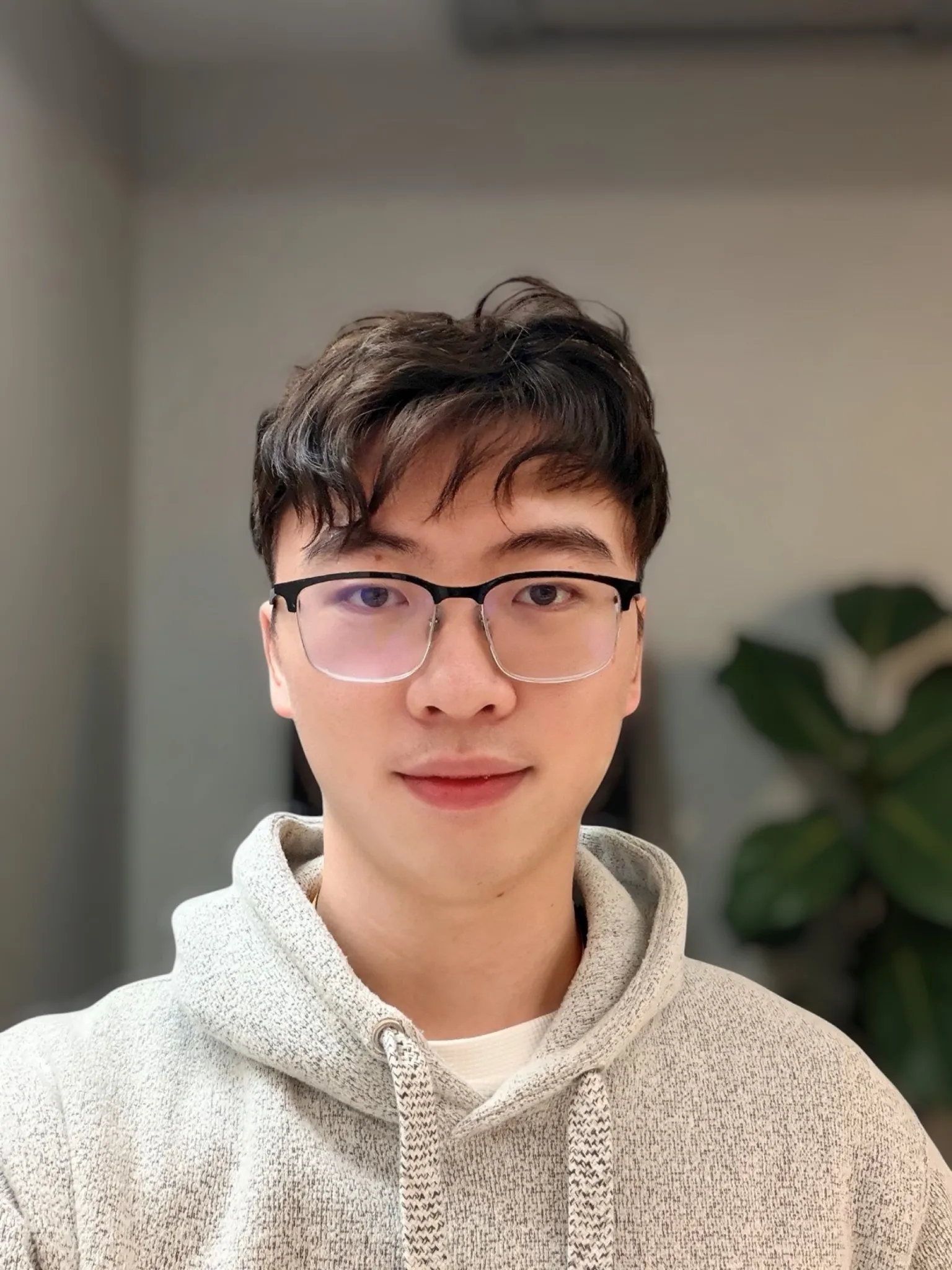 Yuankun Huang at his desk, mid-debug session